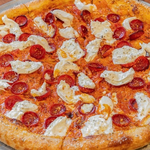 Close-up of a pepperoni and ricotta cheese pizza from Armando's Grill & Pizzeria.